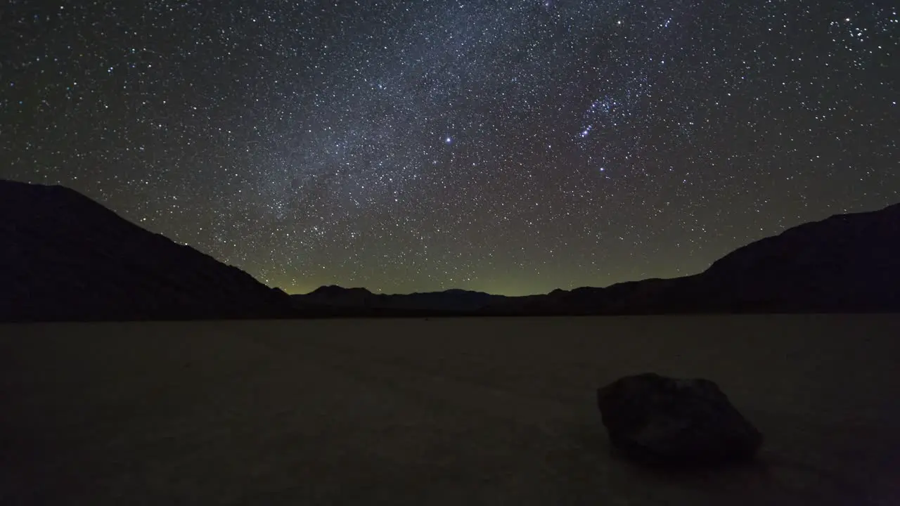 Motion time lapse of the milky way and night sky over a moving rock on the Racetrack Playa