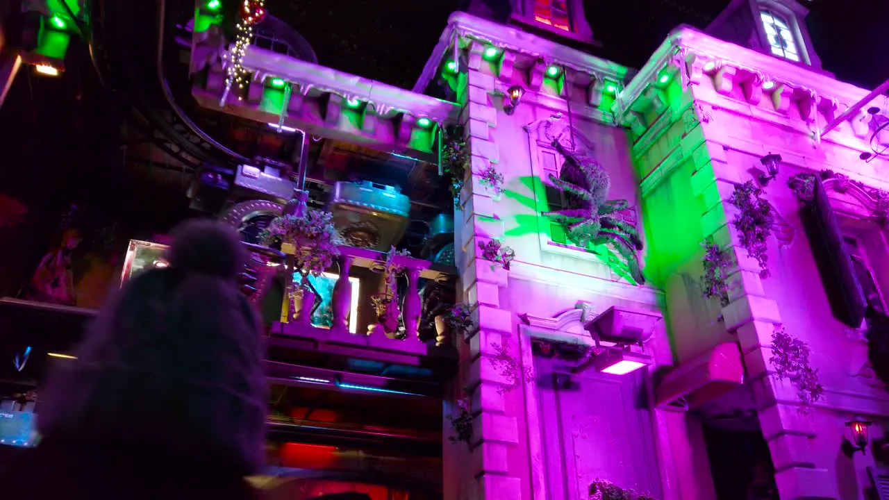 Low angle shot of two tier scary ride going on inside an amusement park in London UK at night time