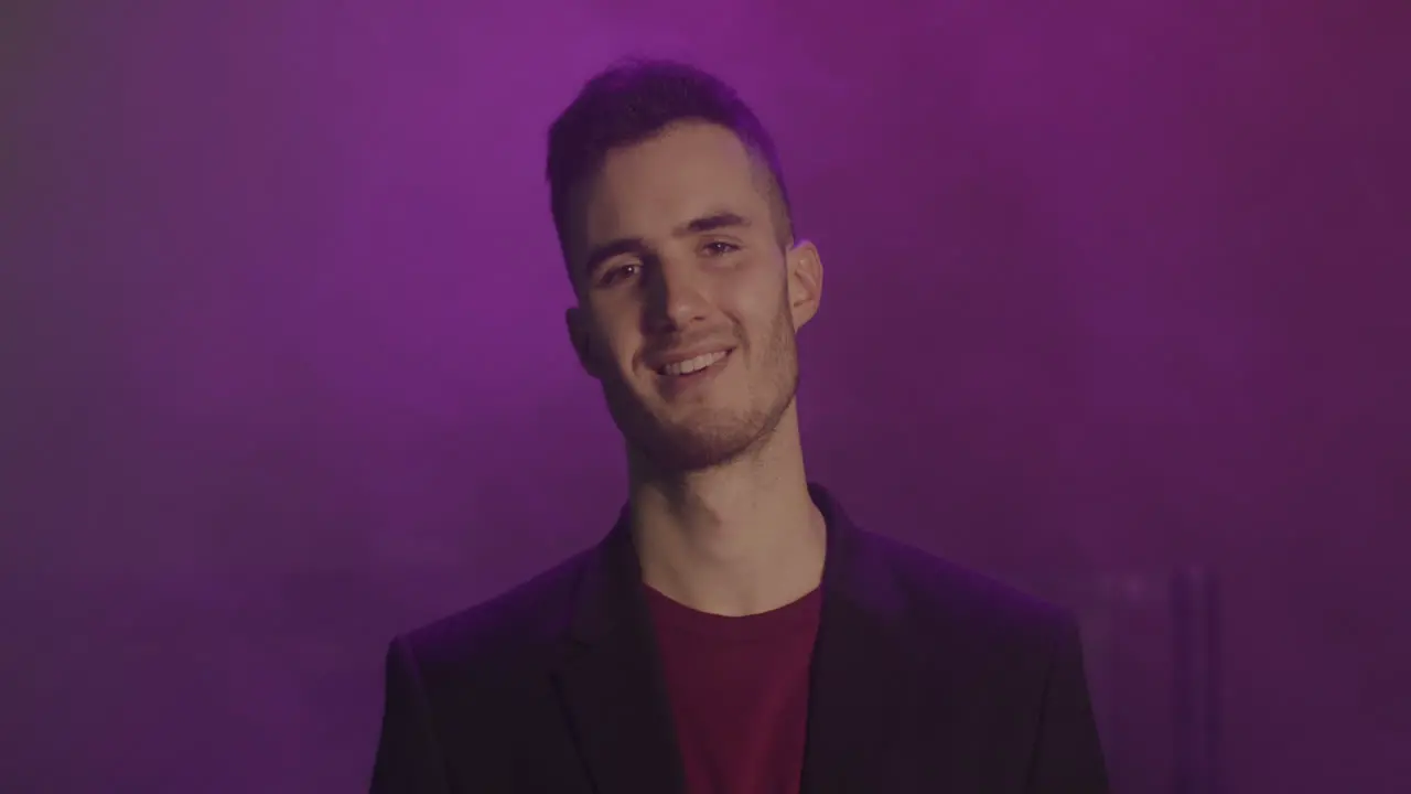 Portrait Of A Young Man Smiling And Looking At Camera At Disco