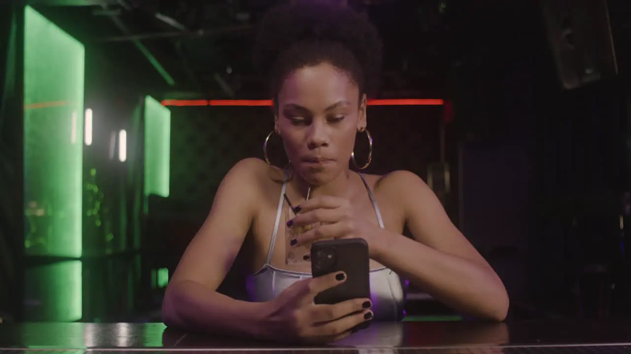 Beautiful Girl Drnking And Taking A Selfie Photo While Sitting At Bar Counter