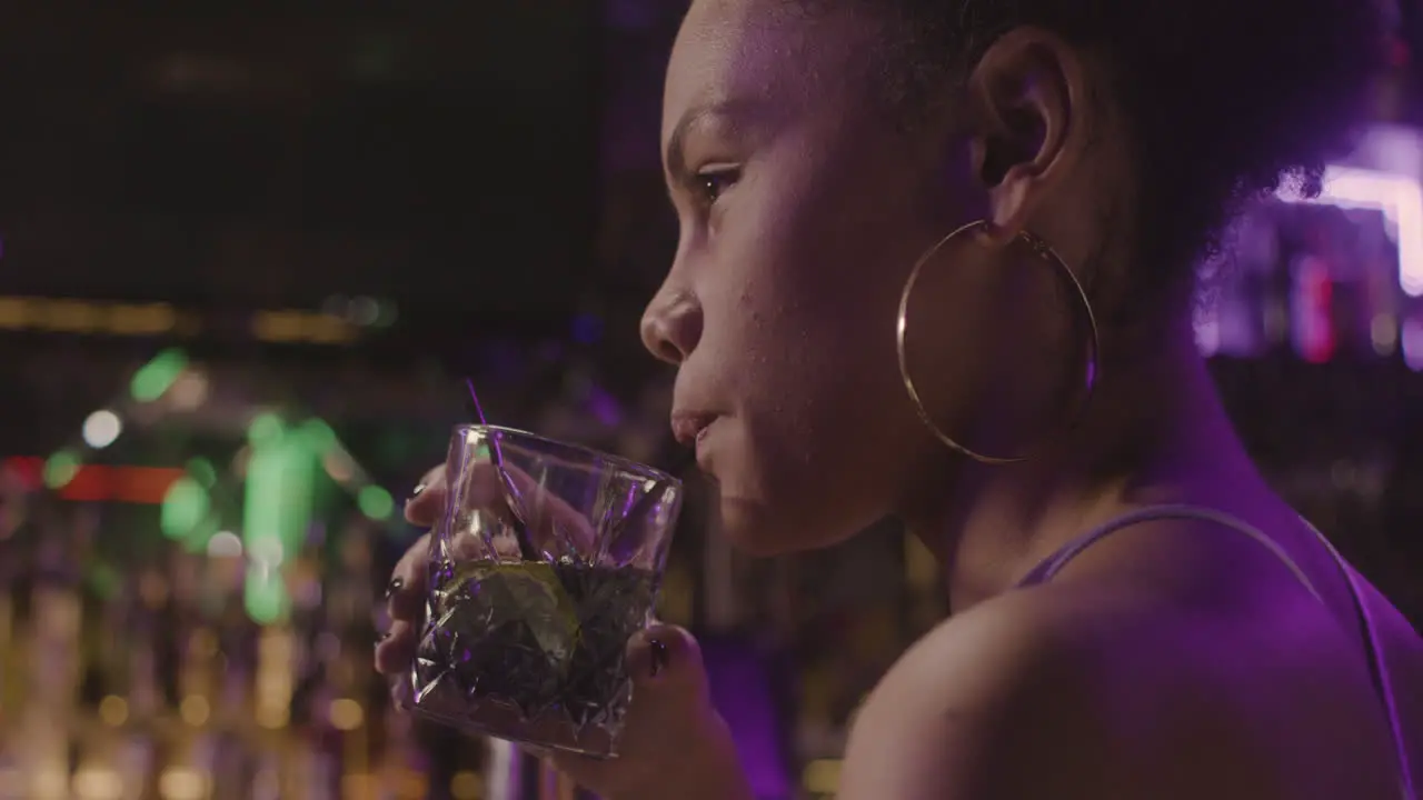 Close Up Of A Happy Girl Drinking And Laughing With Someone While Sitting At Bar Counter