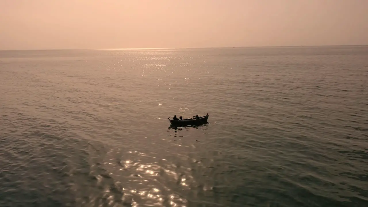 Aerial View Traditional Row Boat Floating In Arabian Sea Against Orange Sunset Sky