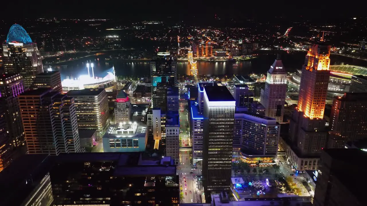 Aerial view around the illuminated skyline of Cincinnati USA circling drone shot