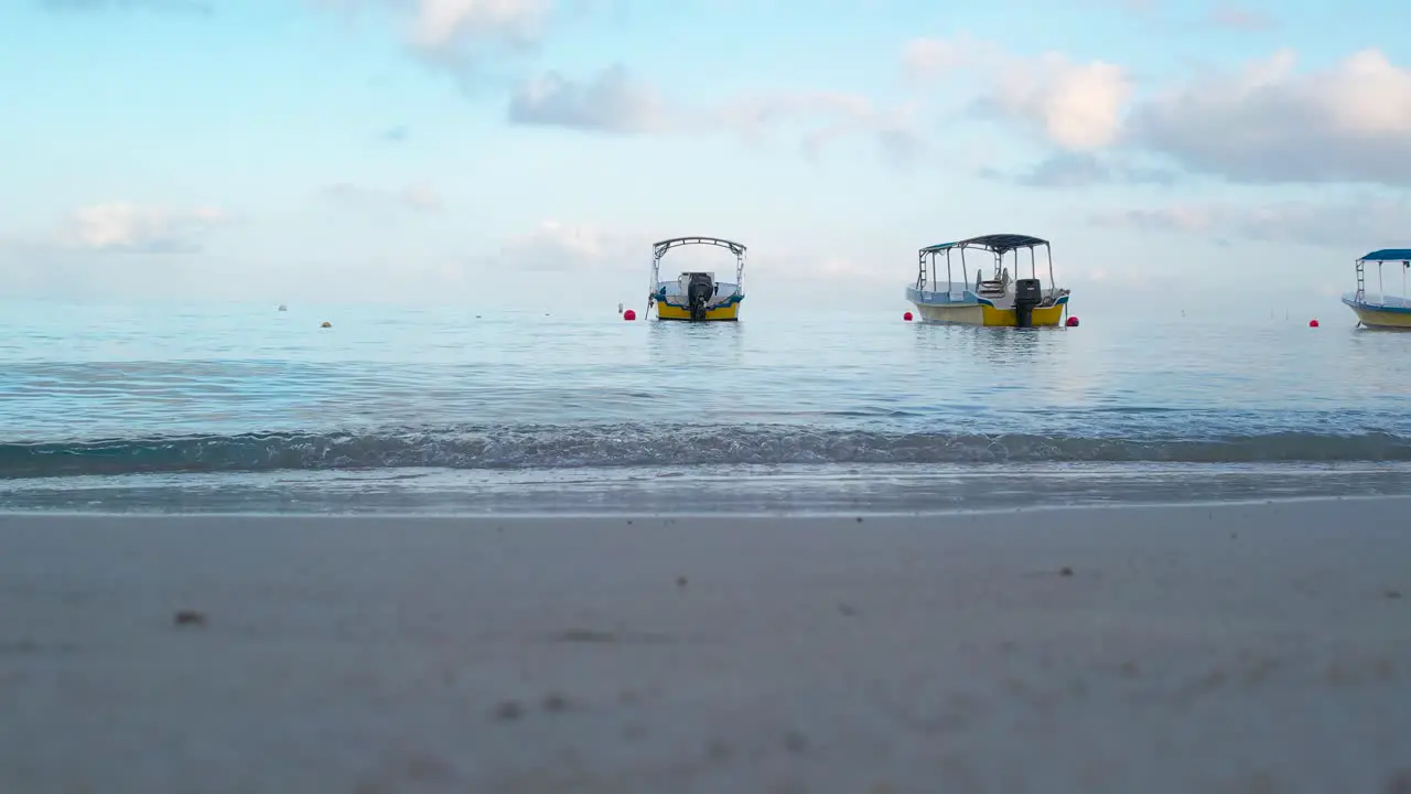 Static footage of White Boat on the waves in turquoise seawater on Caribbean coast