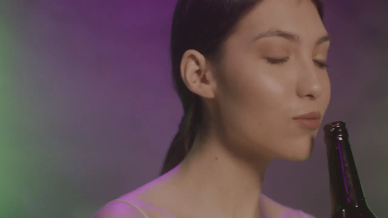 Close Up Of A Beautiful Girl With Braces Drinking Beer And Dancing At Disco