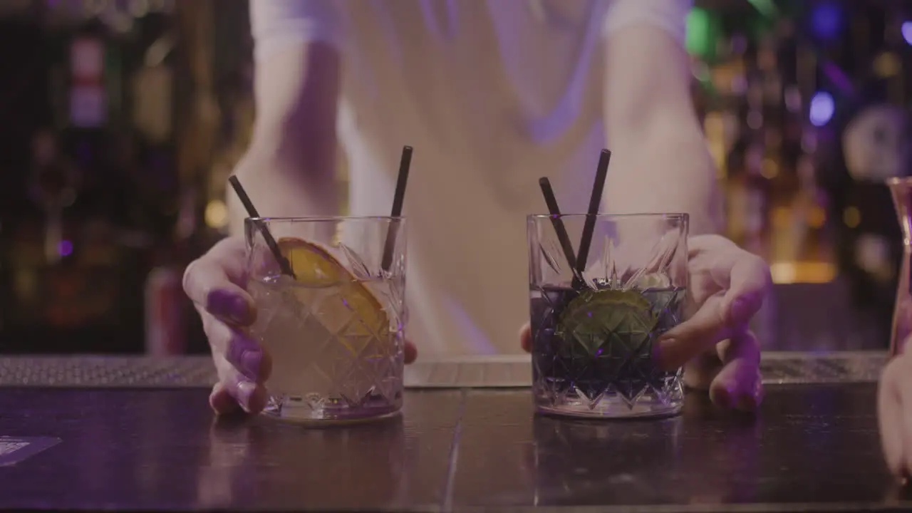 Close Up Of Waiter Serving Drinks To Unrecognizable Couple Sitting At Bar Counter 1