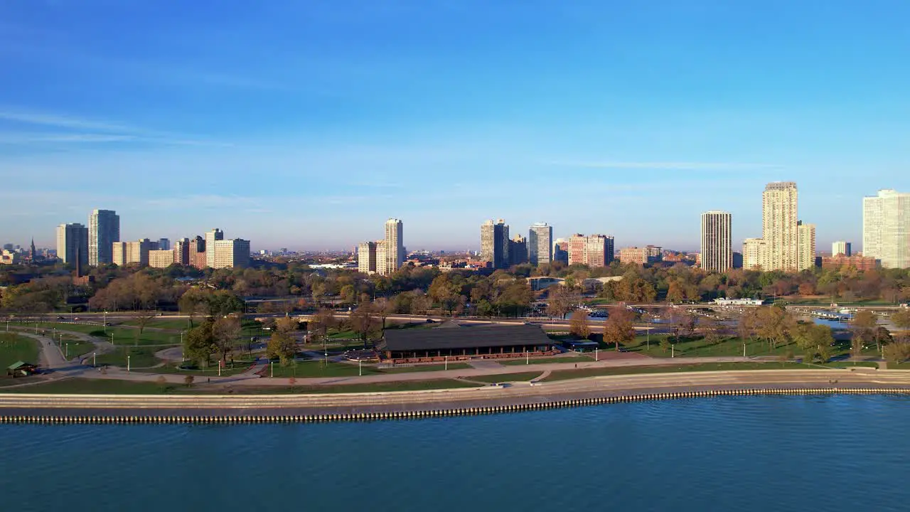 Green City Skyline Next To Lake Shoreline Drone Footage