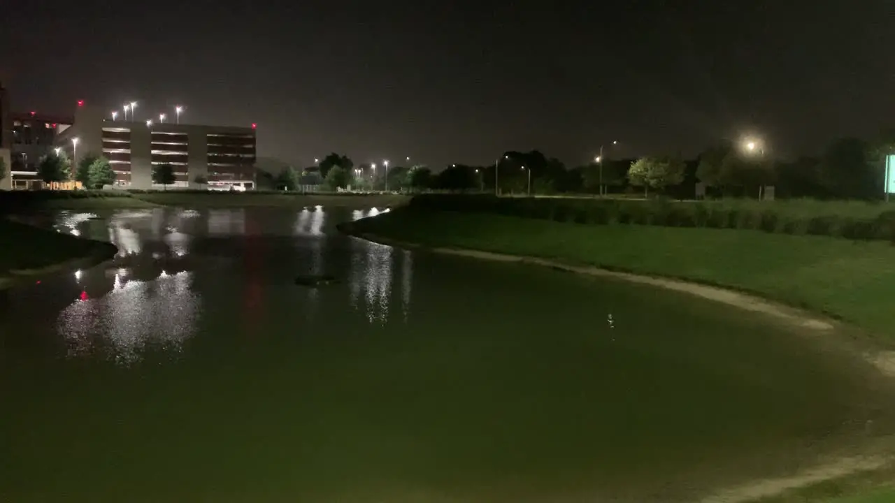 A short clip of a pond next to a hospital at night in Katy Texas