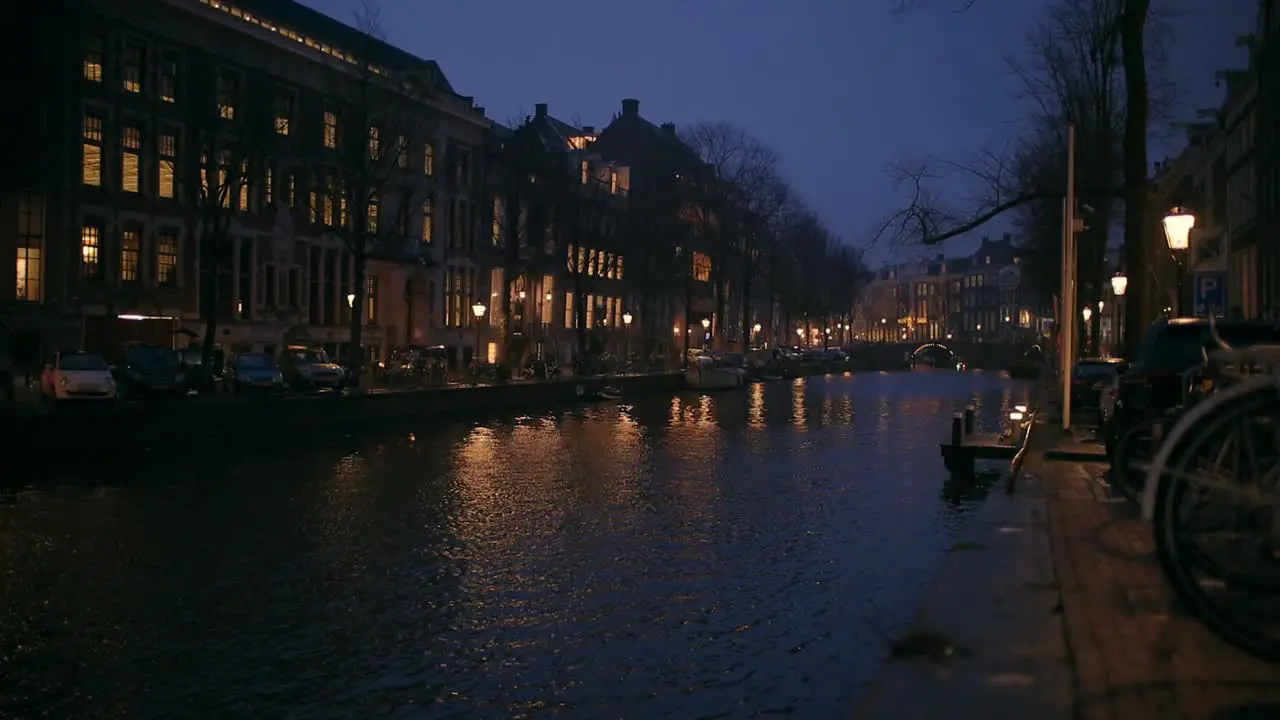 A rainy day in Amsterdam city centre night shot of a cityscape with buildings and a canal