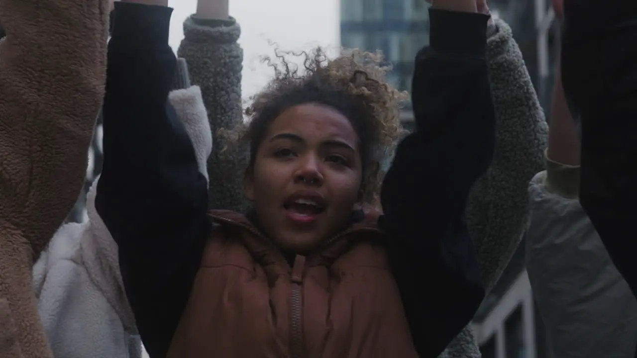 Close Up View Of Activists Raising Fists During A Climate Change Protest In The Street 1