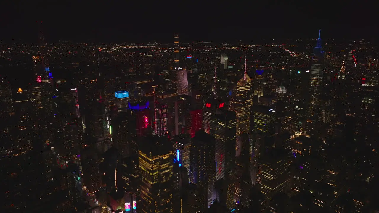 Aerial panoramic view of night city with illuminated skyscrapers Colourful lights of evening town Manhattan New York City USA