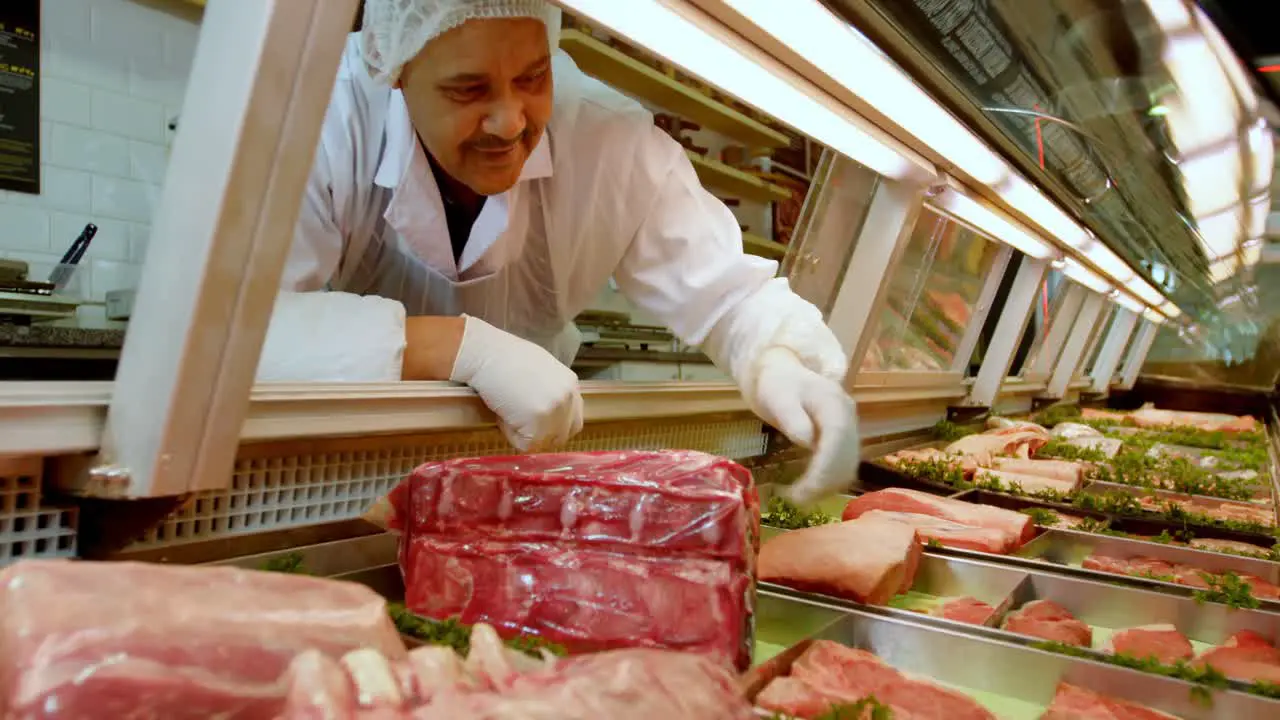 Butcher arranging meat in refrigerator 4k