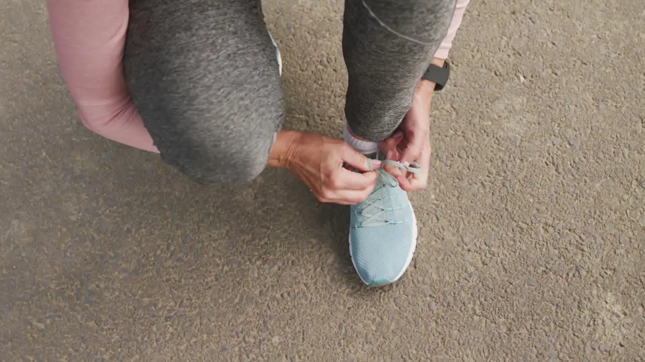 Close up of woman tying shoe laces