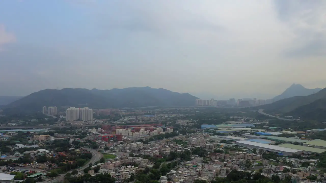 Urbanization of the countryside landscape with buildings houses and a city in the distance during the day