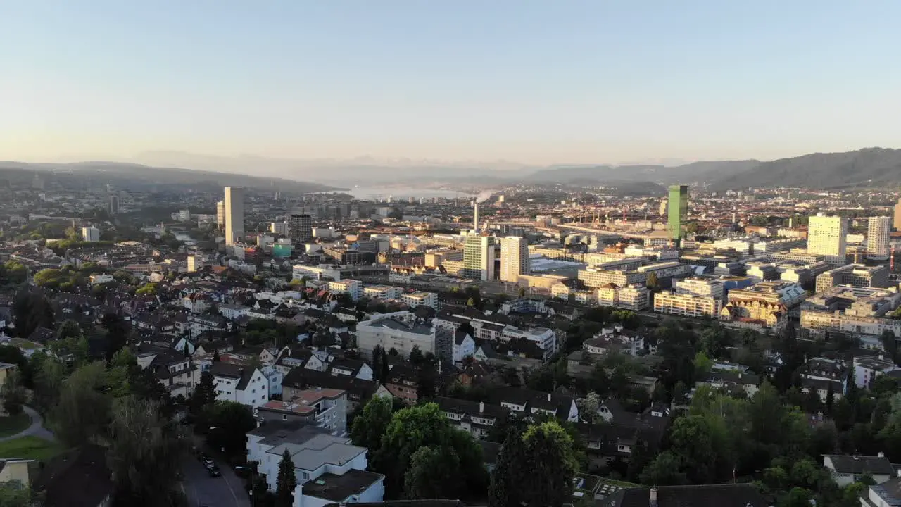 Drone sideways pan above Zürich city at sunrise 4k