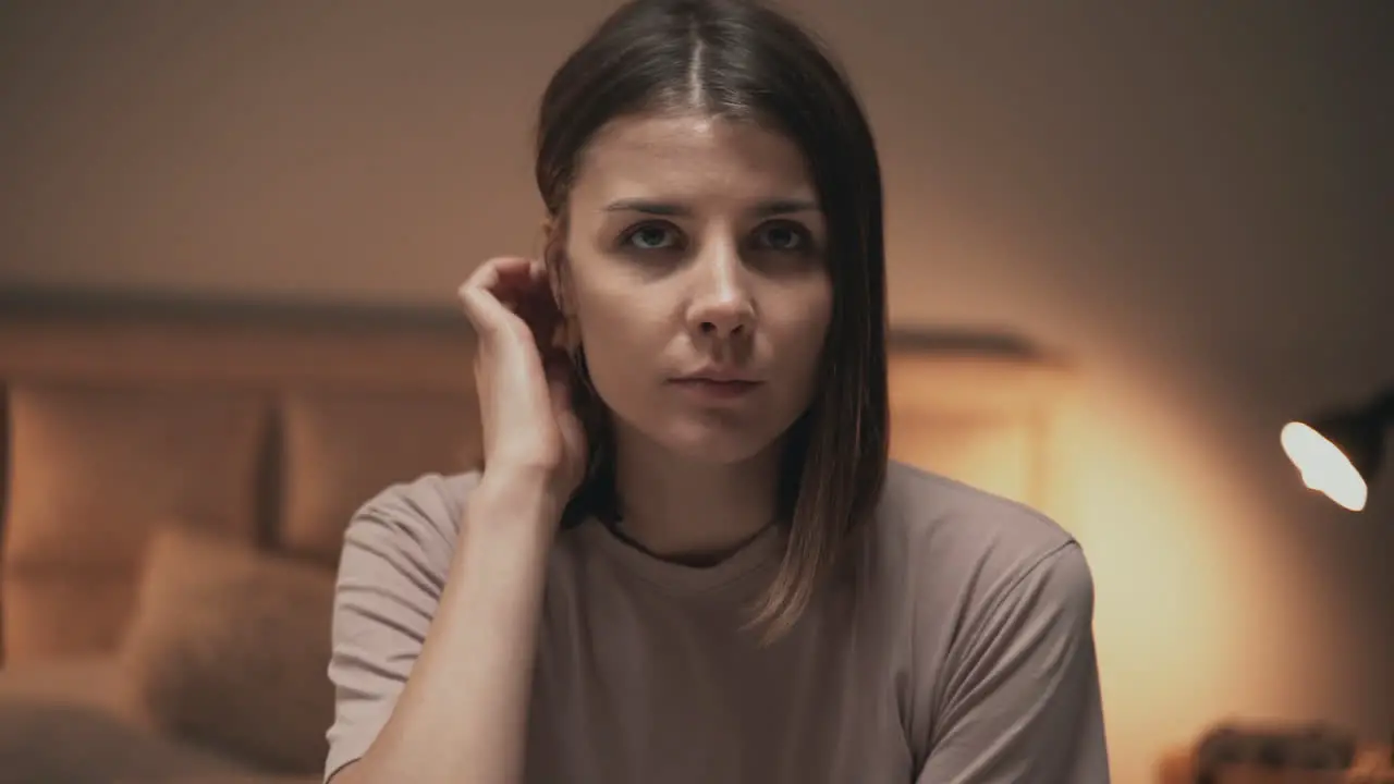 Portrait Of Young Serious Woman Looking At Camera Indoor