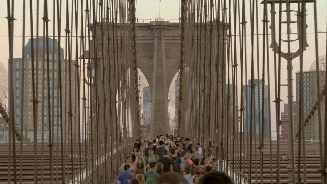 A Crowd of People Walking Across Brooklyn Bridge