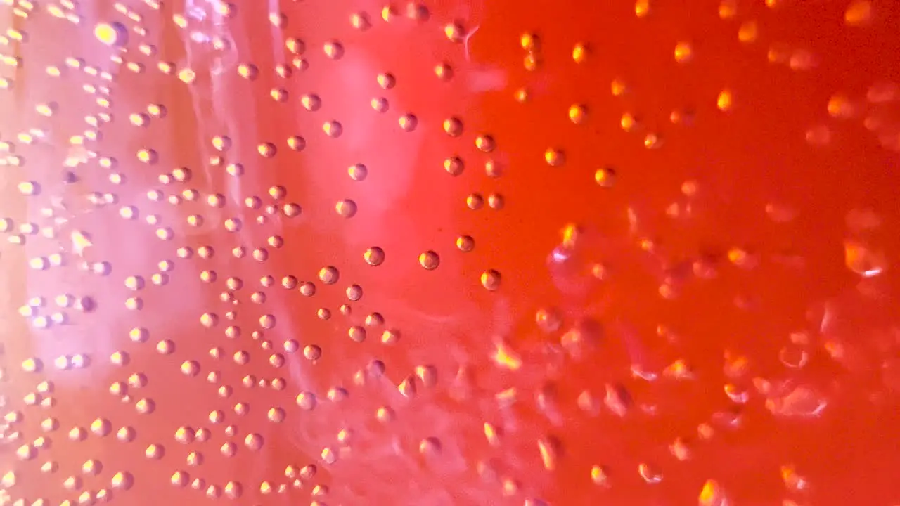 Macro Abstract Red Bubbles Sparkling Blobs into Colorful Bright Fluid Creative Background Texture Liquid Art Light Flare Glare Through the Liquid Flow