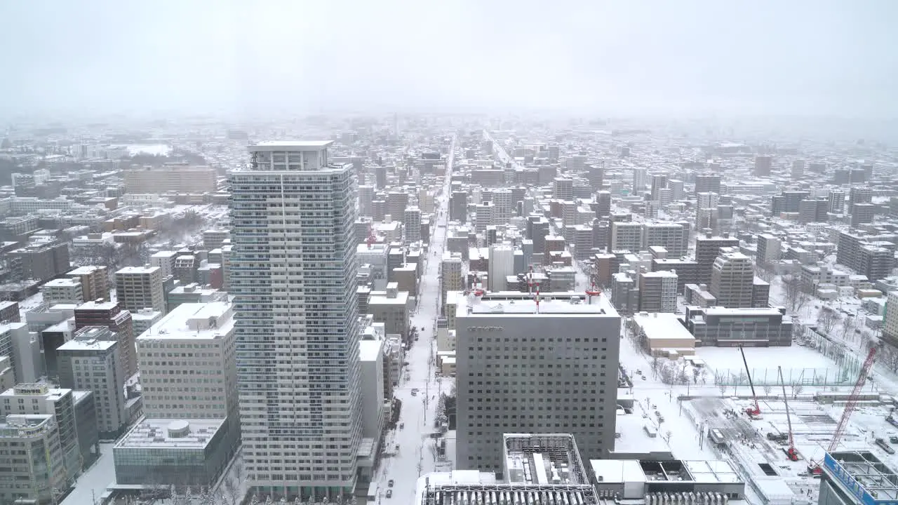 Beautiful daytime view of Sapporo city from above during winter snow