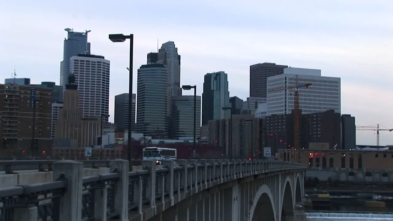 Traffic Moves Across A Bridge Into The City In This Clip