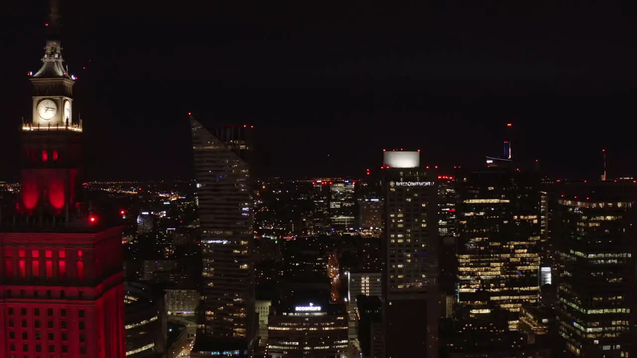 Slider of night downtown Revealing modern tall skyscrapers contrasting with historic PKIN high rise building Warsaw Poland