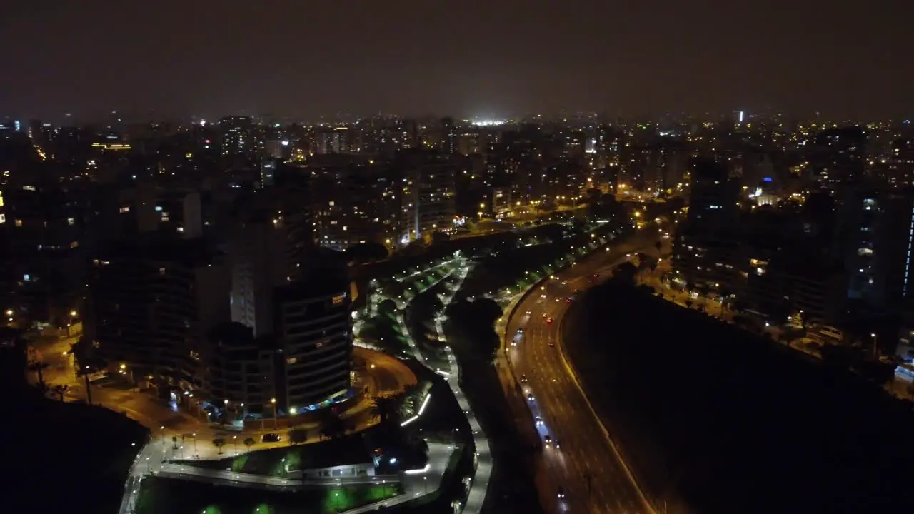 Drone night time video of a street called "Bajada Armendariz" Drone hovers and turns left to right