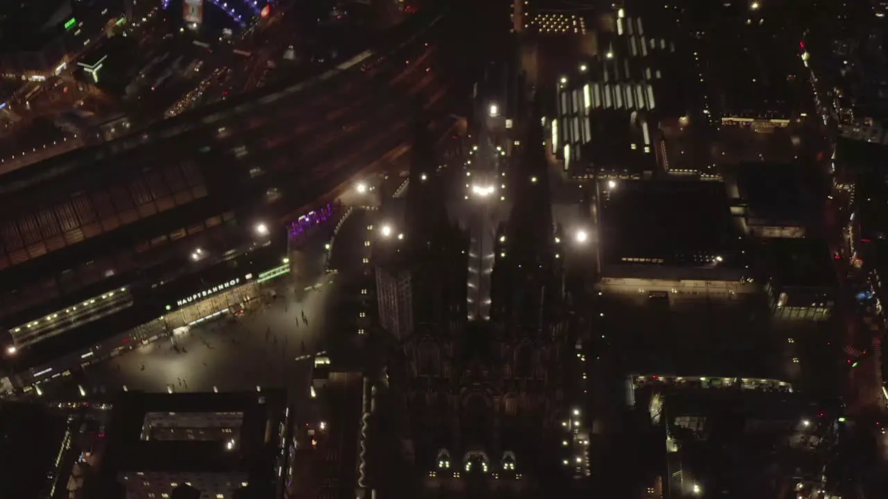 AERIAL Beautiful Overhead Shot of Cologne Germany Cathedral at Night time with City lights