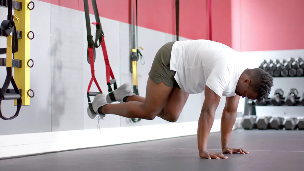 Fit African American man performing a workout at the gym