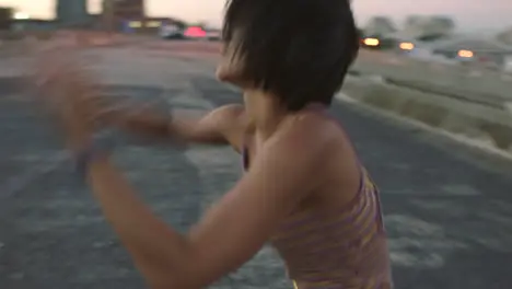 Carefree woman dancing outside in an urban setting