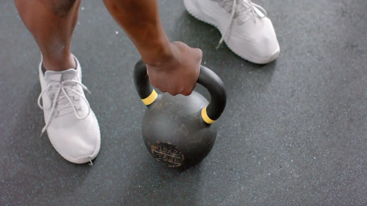 Fit African American man grips a kettlebell at the gym