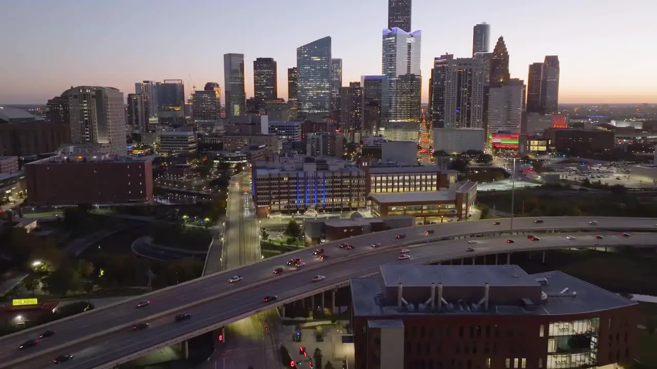 Establishing aerial view of the University of Houston-downtown and the skyline during dawn