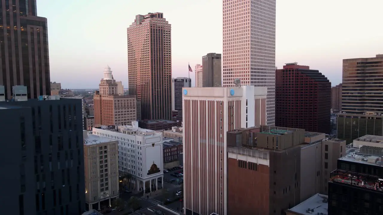 Aerial view in middle of skyscrapers sunny evening in New Orleans USA ascending drone shot