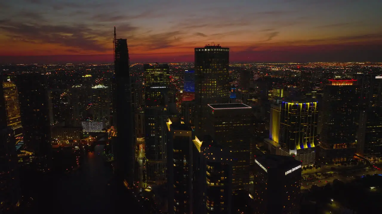 Aerial evening shot of high rise downtown buildings against colourful sky after sunset Illuminated town development Miami USA