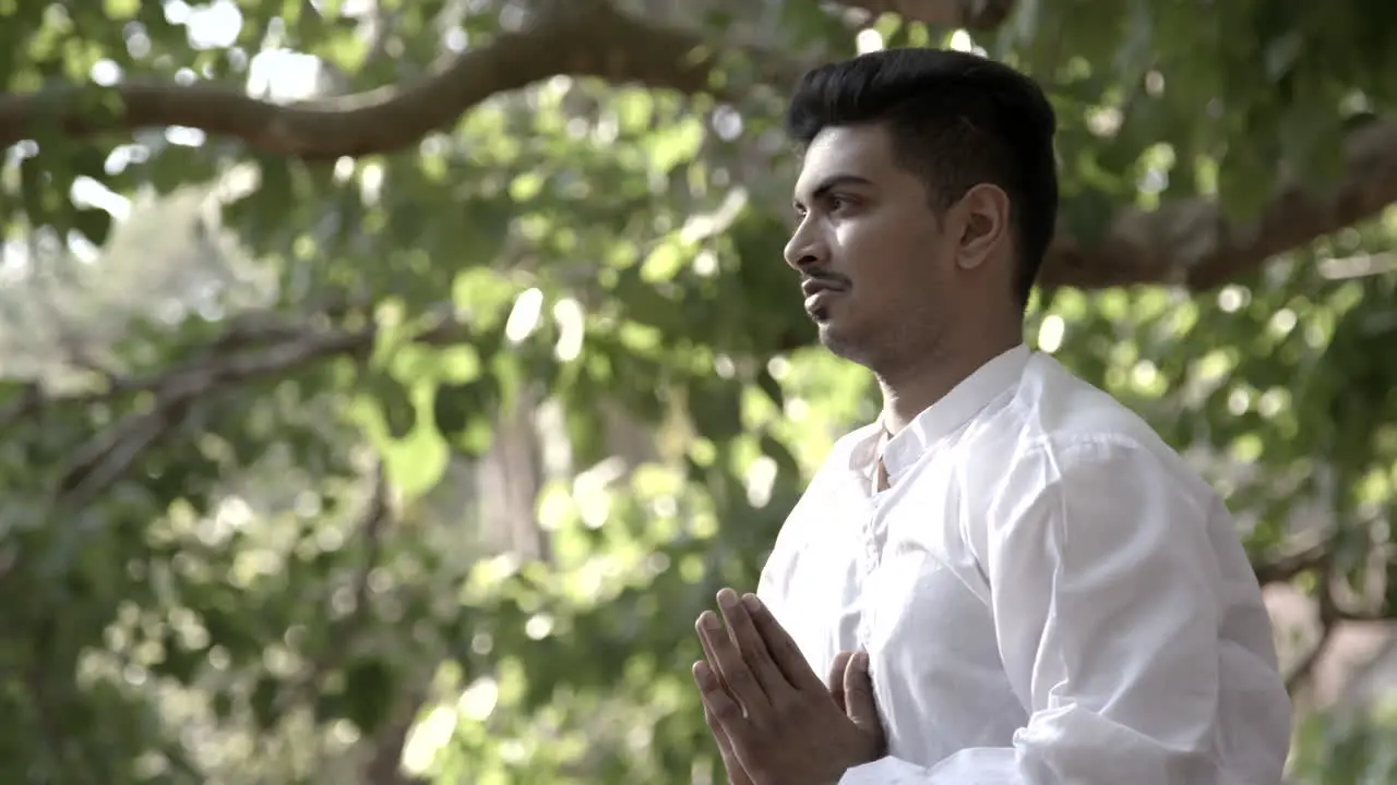 Attractive Asian man does yoga poses on the steps of a temple