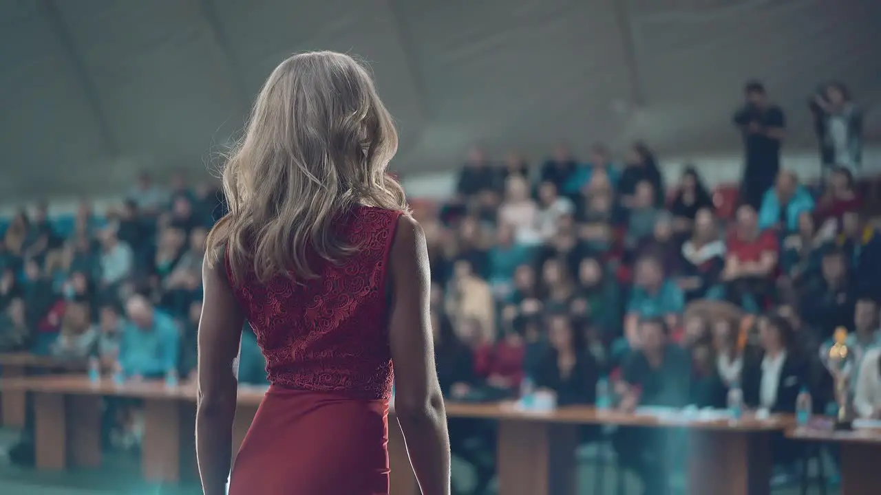 Beautiful girls who are engaged in fitness during the beauty contest They perform on stage in red evening dress