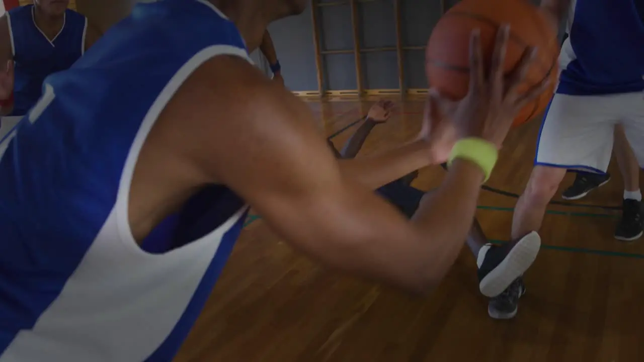 Group of diverse team of male basketball players playing basketball in the court