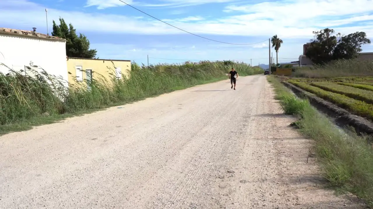 Person running and doing sports on a dirt road