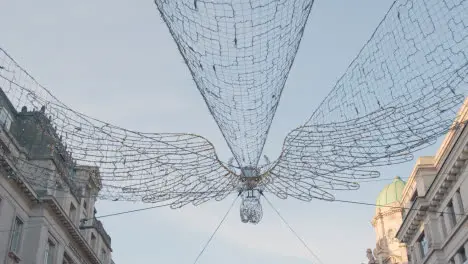 Close Up Of Angel Christmas Light Decoration Across Shops On London UK Regent Street In Daytime