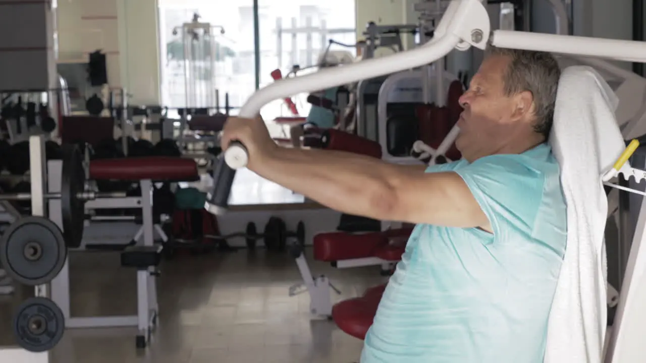 Mature man exercising on chest press machine