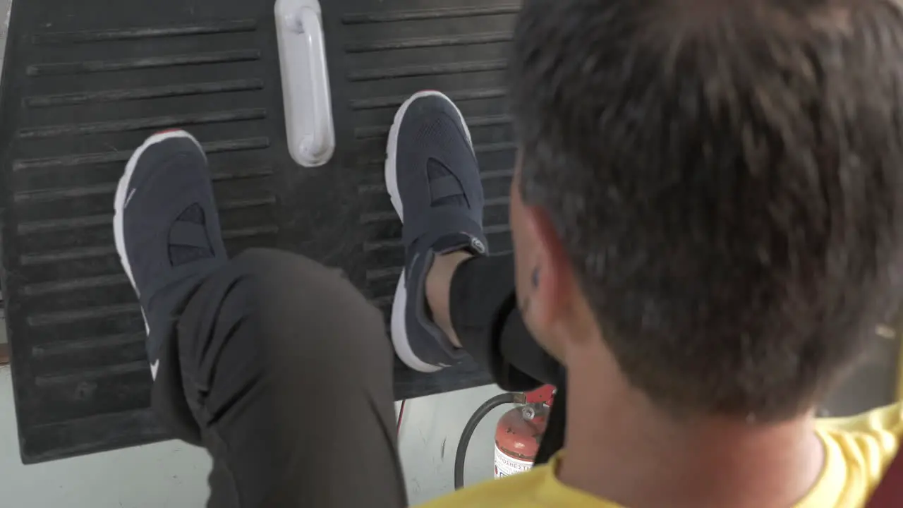 Young man training on leg press machine