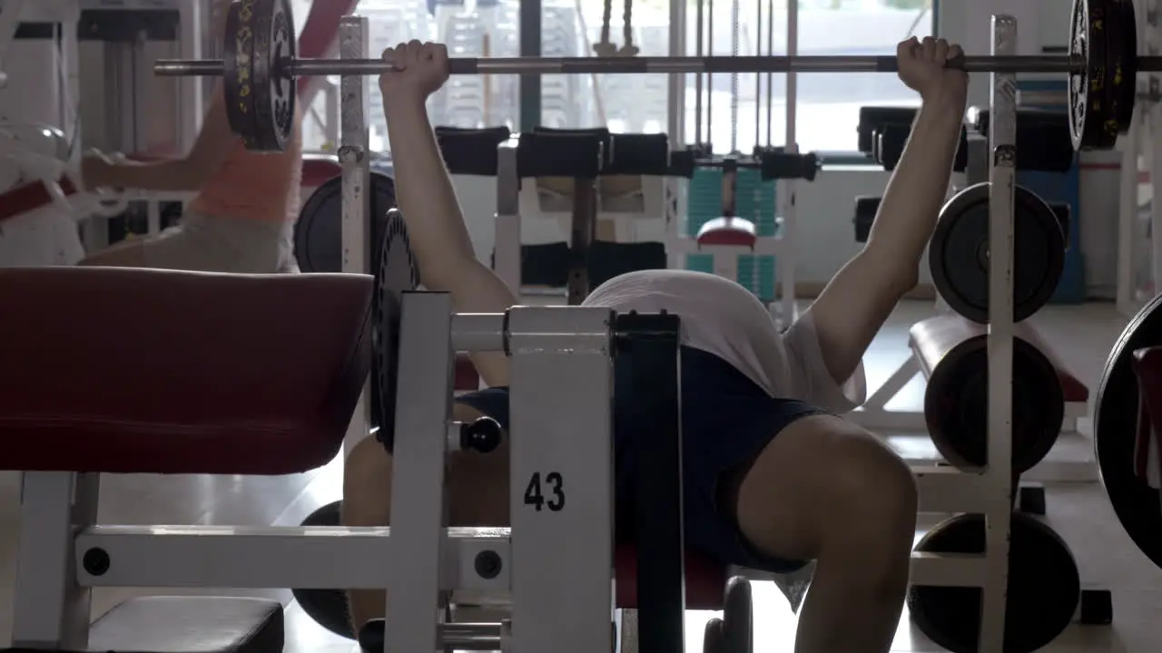 Man doing bench press exercise in the gym