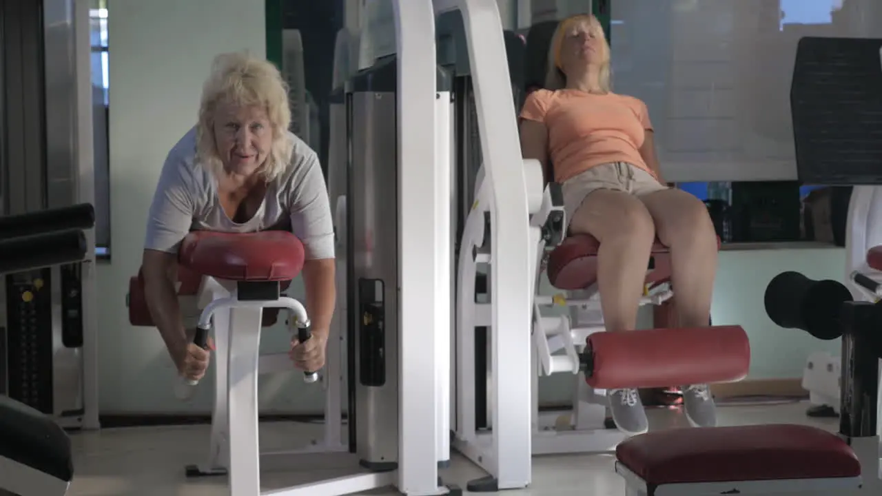 Women doing leg exercises on fitness machines