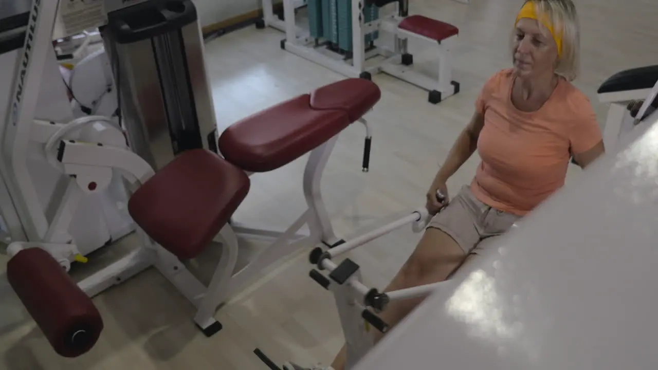 Senior woman working out on exercise machine