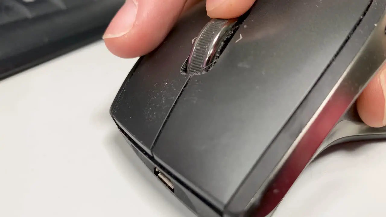 Male hand uses a computer mouse in an office in close-up