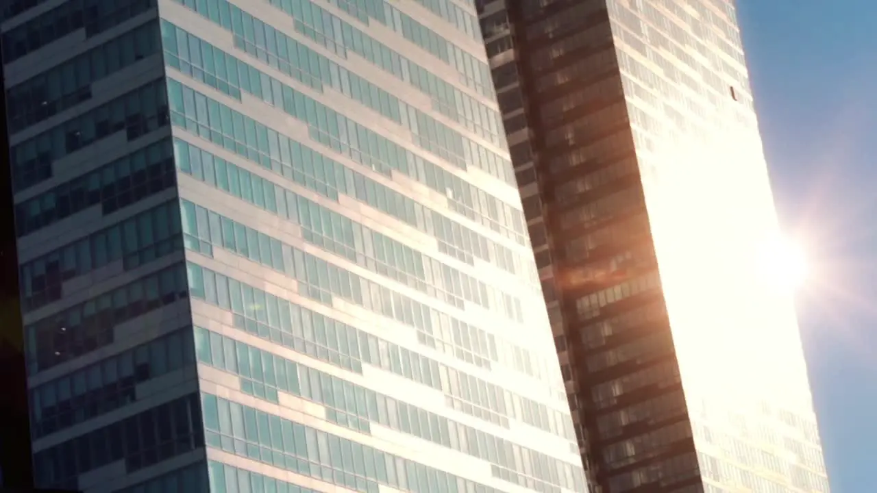 City Commuting Independently Between Glass Buildings Building And Suny Sky