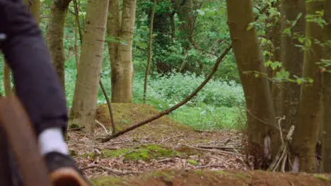 Slow Motion Shot Of Man On Mountain Bike Making Mid Air Jump On Dirt Trail Through Woodland 14