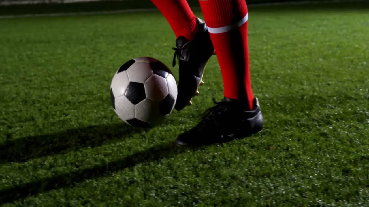 Low section of soccer player and ball on field 4k