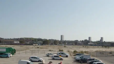 Panning Shot of Cars Parked In Front of Desolate Construction Site