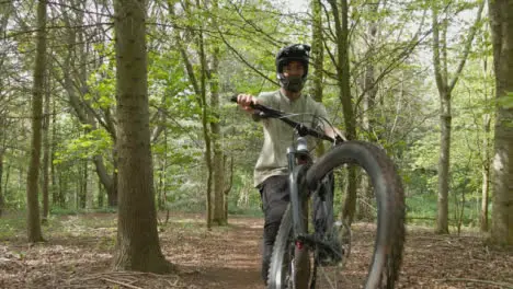 Drone Tracking Man On Mountain Bike Cycling Along Trail Through Countryside And Woodland 2