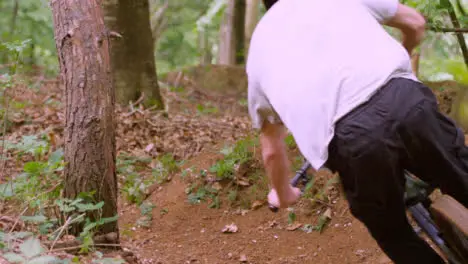 Close Up Slow Motion Shot Of Man On Mountain Bike Cycling Along Woodland Trail 